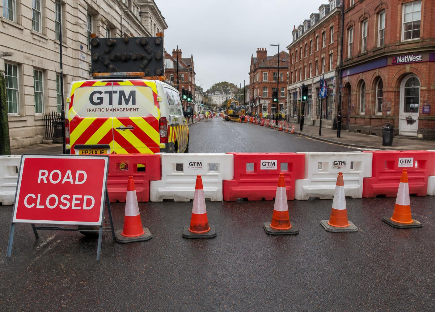 Road closed signage, barriers and cones across a UK city street